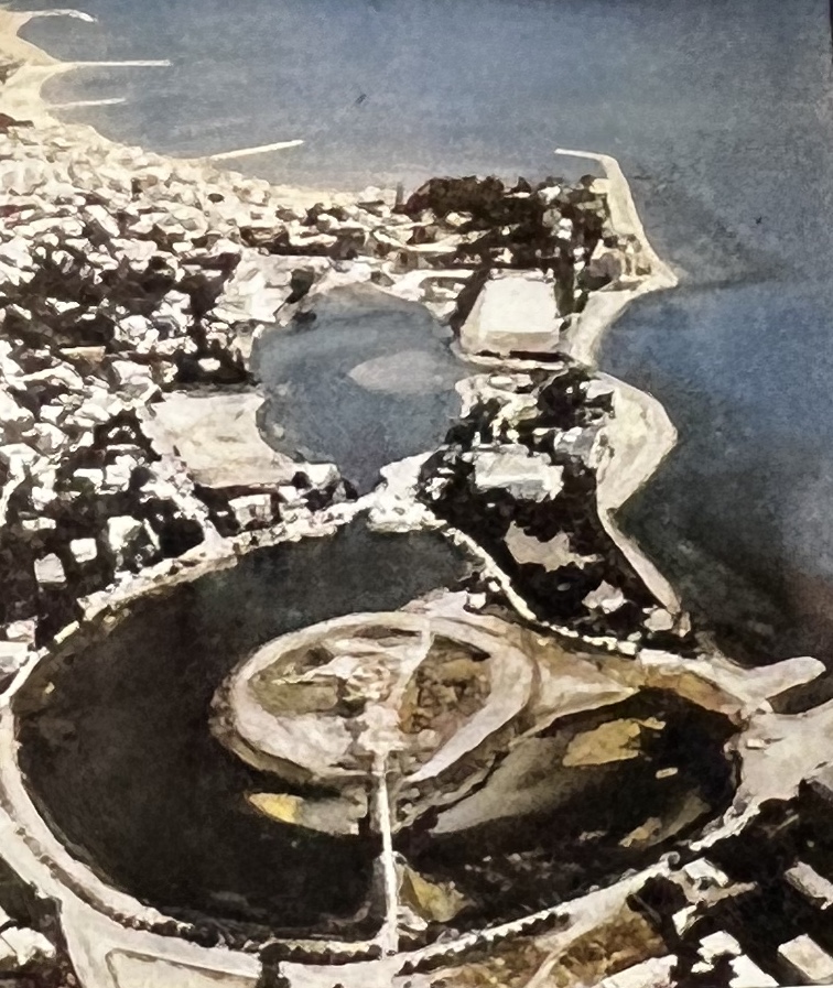 Aerial view of the circular harbour with the central island and the ancient access causeway still surviving.