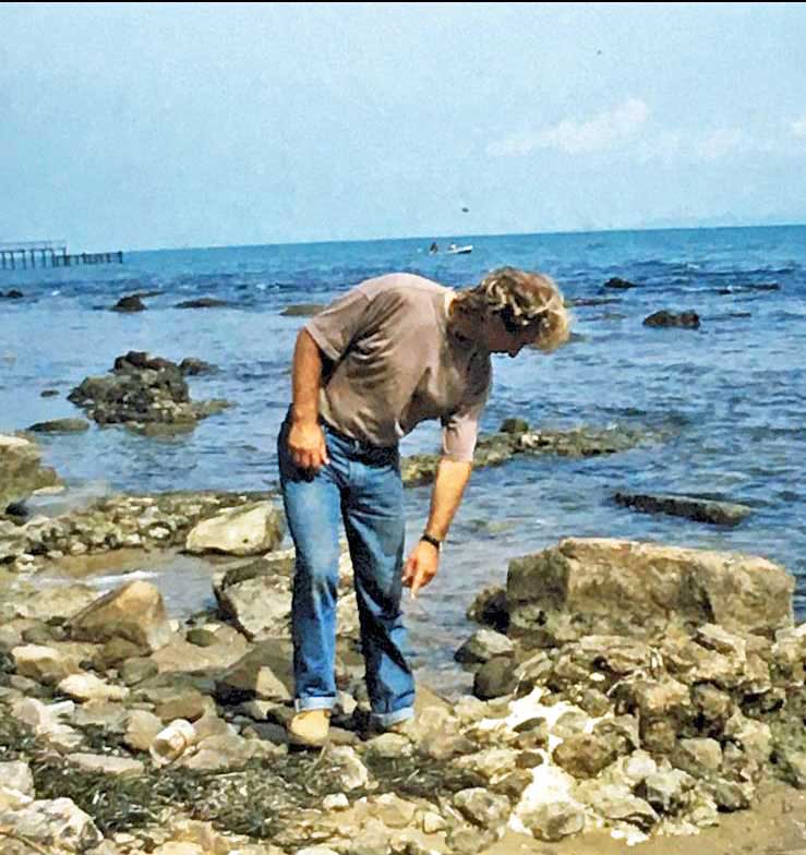 The remains of waterfront warehouses are still visible, partially submerged by rising sea levels.
