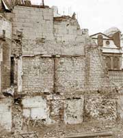 Photo of the face of a 15th century wall, surviving from the foundation level to the top floor