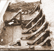 An early C13th structural revolution: a cross-braced timber framed jetty extended from an earlier earth-fast revetment Museum of London