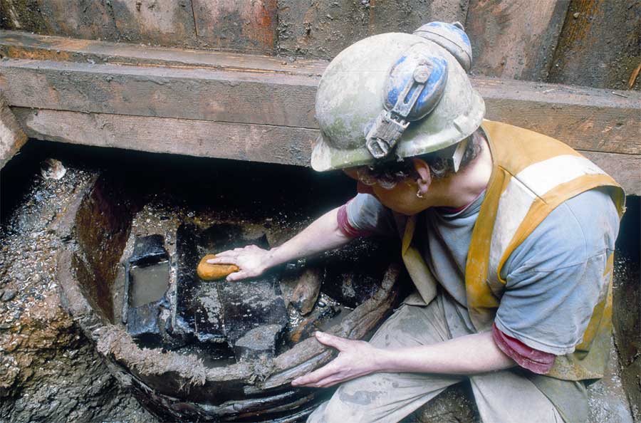 Softwood halved barrel at the bottom of the west well, one of the hollowed-out oak water-boxes can be seen in situ in the left-hand side of the barrel