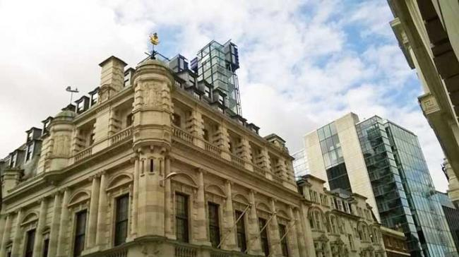 The ornate Collcutt building (complete with two ship weather vanes) looking south–west from the corner of Fenchurch Street and Lloyd’s Avenue, the top of the Rogers building appears just above the roof line