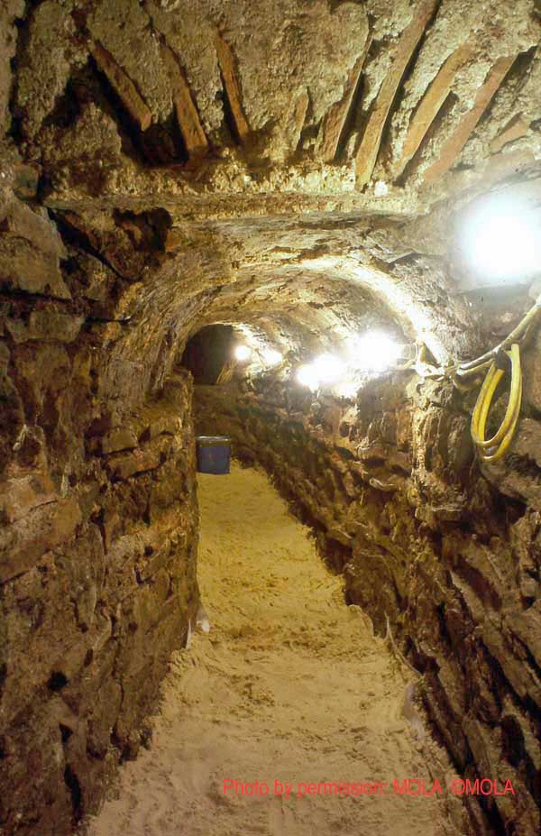 The time capsule in place in the culvert, the stygian darkness beyond, marks the entry into the unexcavated south end of the structure, which Duncan Lees crawled into (complete with prism, torch and dead canary in cage)