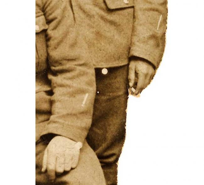 Detail of the ‘wound stripes’ on the lower left-hand sleeves of both soldiers