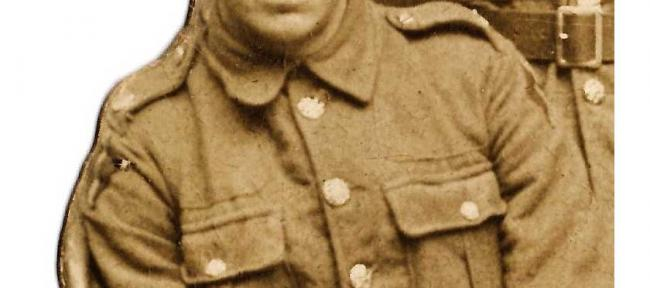 Oblique detail of the ‘shoulder badges’ on the seated soldier