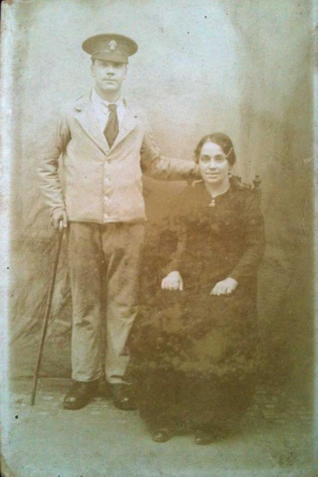 Joseph Blair at the side of his mother Louisa Mary Anne Blair. Had the photo been in colour, it would be evident   that he was dressed in a uniform known as the ‘Convalescent Blues’ worn by soldiers in military hospitals. The   uniforms were made of blue flannel lined with white, worn with a white shirt and red tie. They were loose and ill-  fitting, and many patients had to turn up or cuff the trouser legs.